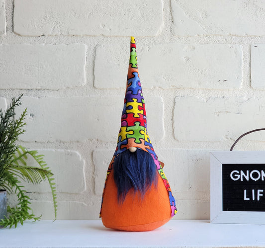 Autism Awareness Gnome with navy blue beard & orange body. This handmade KyElle Kreations gnome measures 9 inches.. Displayed with faux foliage and seasonal accent decor.