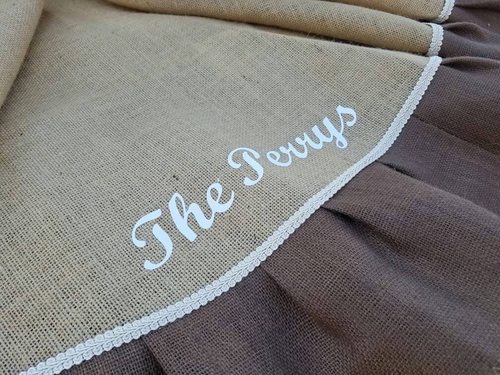 Tan Burlap Christmas Tree Skirt with Chocolate outer ruffle. Skirt is personalized with family name, The Perrys in cream with coordinated cream trim.