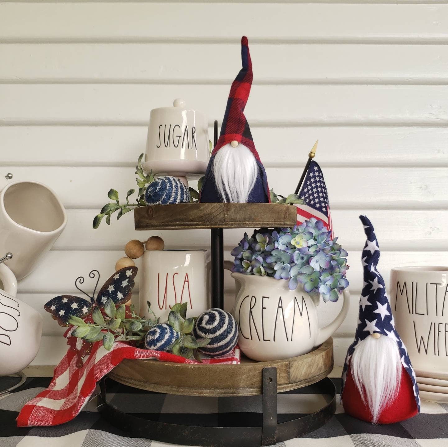 Tiered tray Coffee Bar display with 2 Patriotic Gnomes in plaid and star pattern prints. Accented with flag decor and foliage.