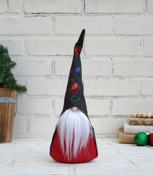 Christmas Light Gnome with white beard & red body. This handmade KyElle Kreations gnome measures 9 inches.. Displayed with faux foliage and seasonal accent decor.