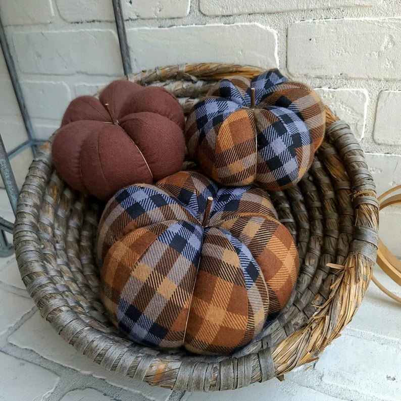 Pumpkin trio set in Chocolate plaid. One large & one small in Chocolate plaid and one small in solid brown color. Displayed in hand woven basket