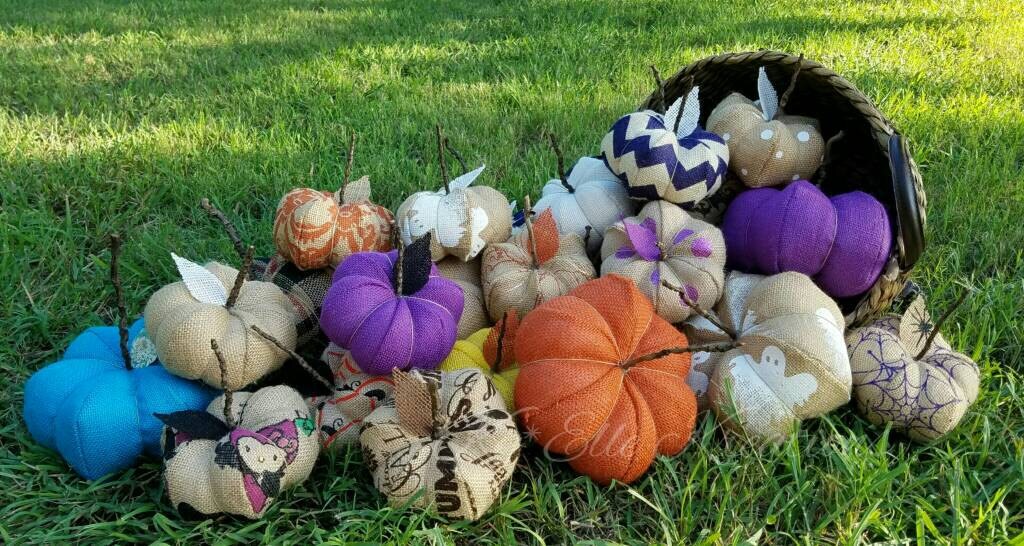 Overflowing woven basket, filled with handmade burlap pumpkins in Halloween & fall colors.
