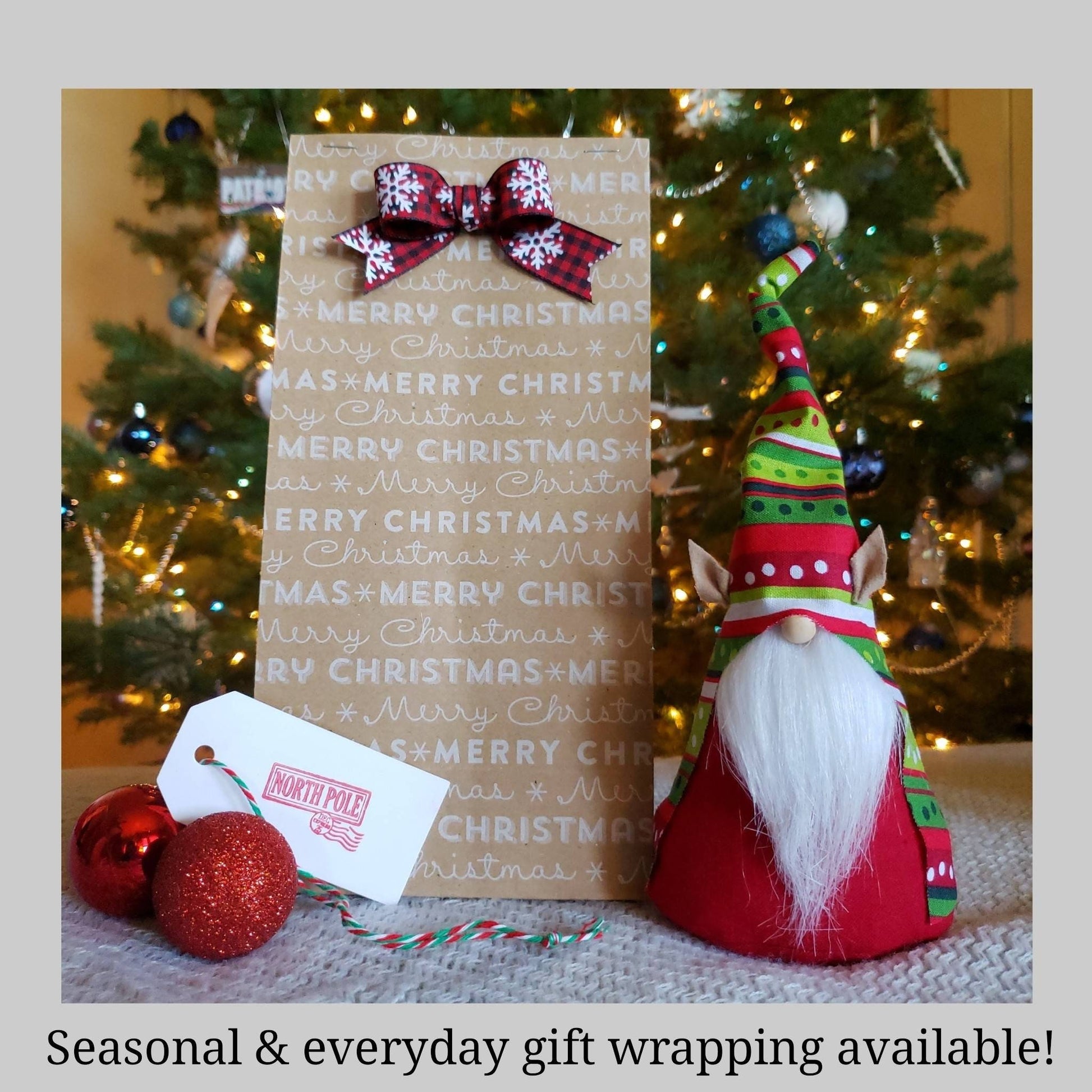 Seasonal and everyday gift wrapping available. festive Elf Gnome with Christmas gift wrapping option shown with Christmas Tree in background. 