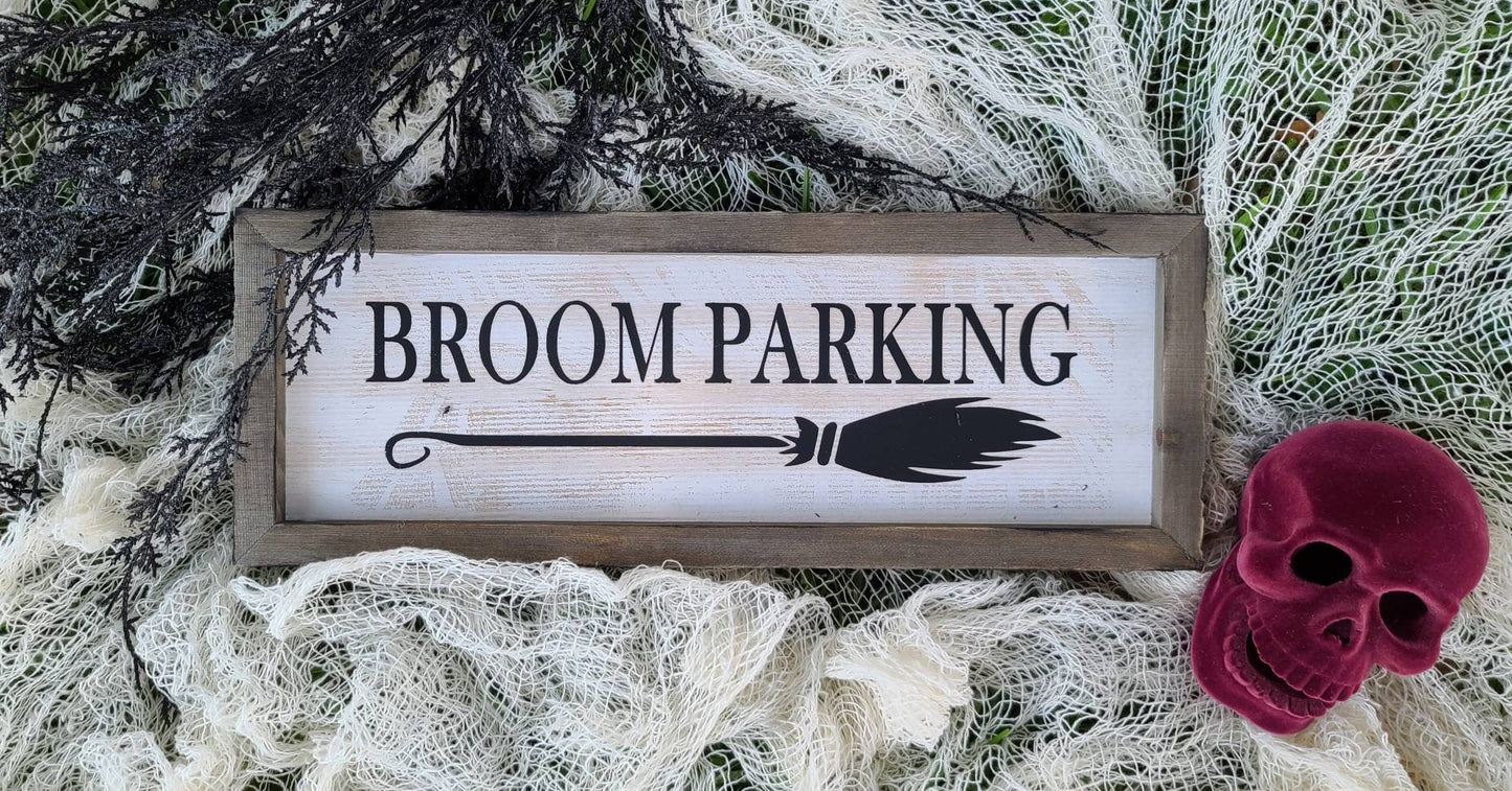 Broom Parking sign measuring 15x5.5 inches. White based sign with black print, outer frame in natural wood with slight distressing to give aged appearance. 